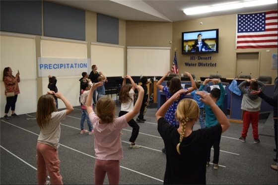 Kids participating in a YouTube Video Water Dance learning about the water cycle.