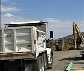 Photo of large excavator working to install Phase 2 Sewer collection system.