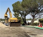 Photo of large excavator working to install Phase 2 Sewer collection system.